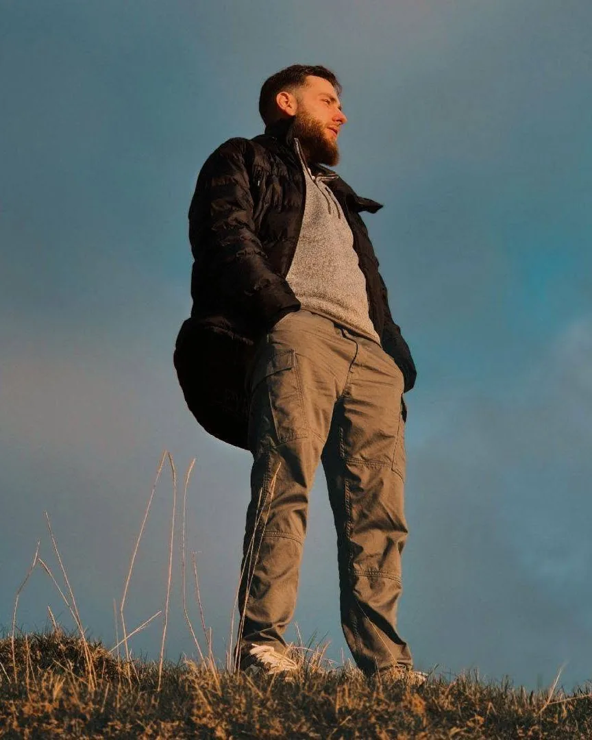 Andrew A. Stewart standing on a hillside in Argyll against an open sky.
